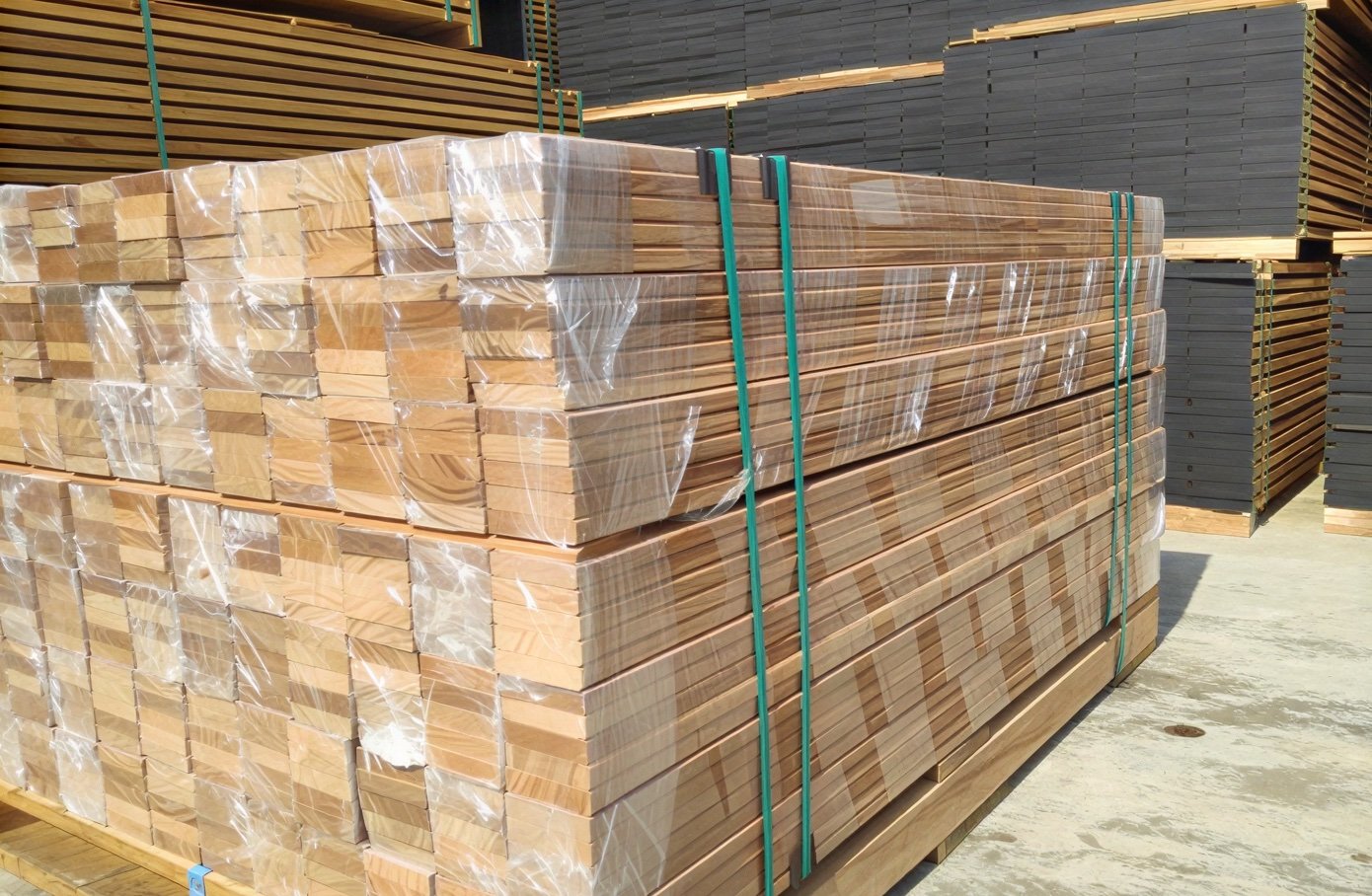 Shrink-wrapped lumber bundles strapped and ready for shipping